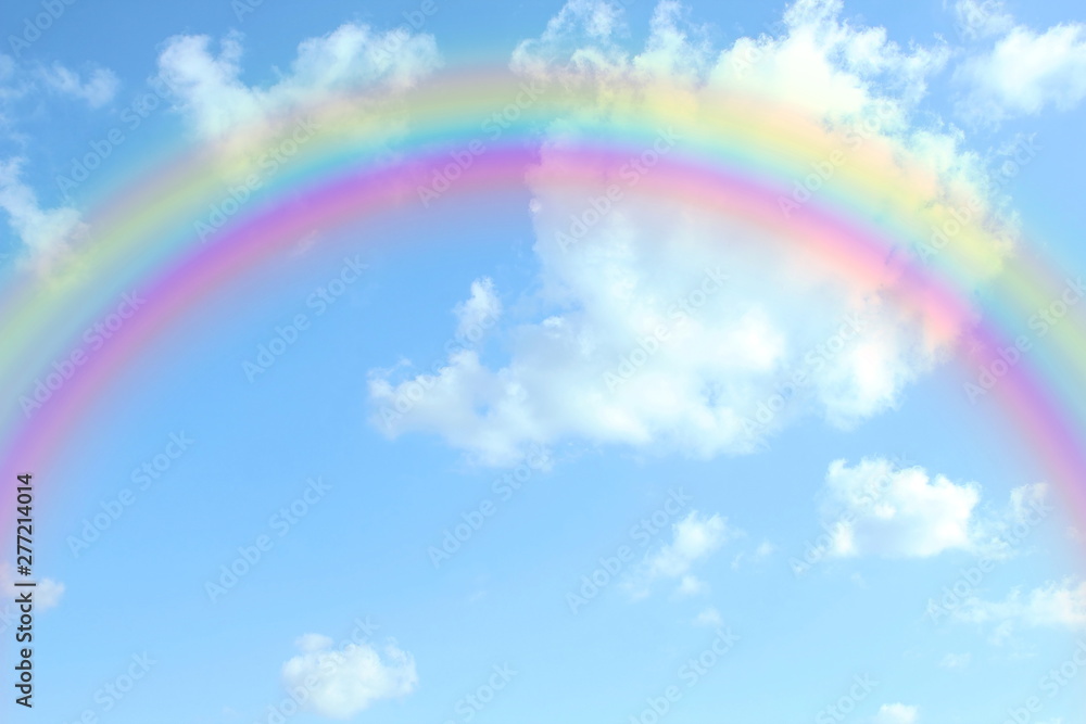 beautiful colorful rainbow in the blue sky with cloud as background beautiful colorful rainbow in the blue sky with cloud as background