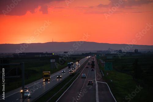 Fototapeta Naklejka Na Ścianę i Meble -  Sunset on the highway with traffic