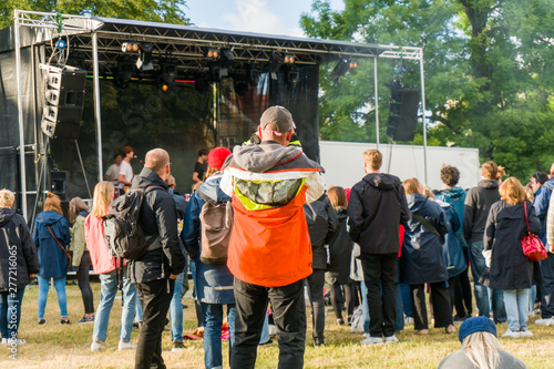 Photographer taking a photo of people listening to a band on a music festival