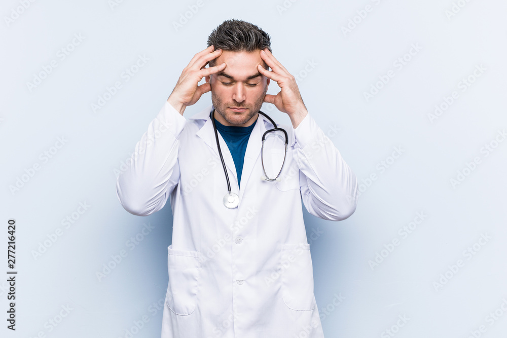 Young handsome doctor man touching temples and having headache. Young handsome doctor man touching temples and having headache.