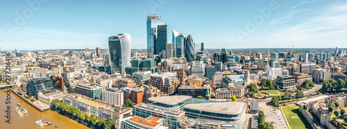 London rooftop aerial view at the morning light with urban architectures, modern skyscrapers like the Shard and city of London and Thames River by the Tower Bridge.