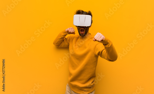 Young man wearing a virtual reality glasses