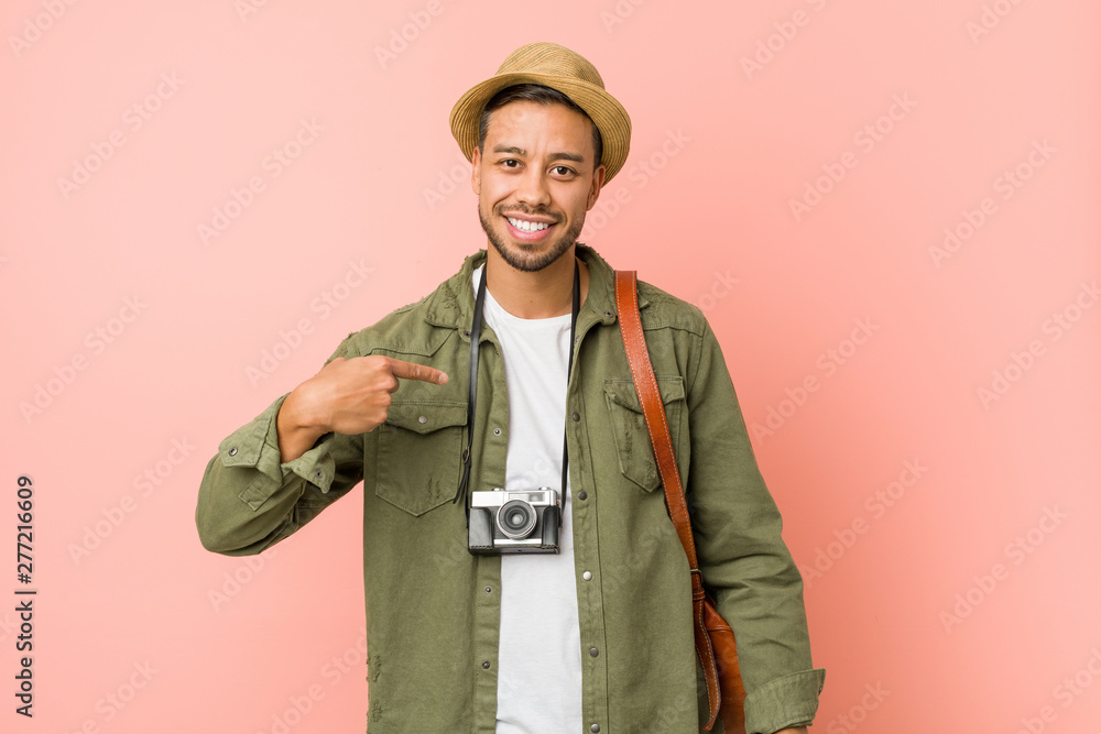 Young filipino traveler man person pointing by hand to a shirt copy space, proud and confident Young filipino traveler man person pointing by hand to a shirt copy space, proud and confident