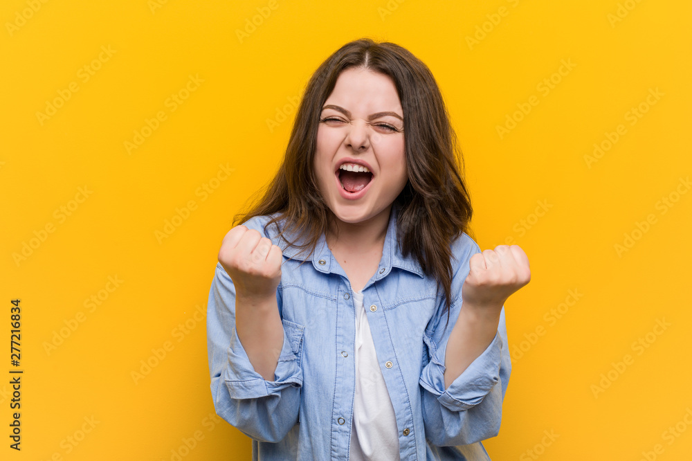 Young curvy plus size woman cheering carefree and excited. Victory concept. Young curvy plus size woman cheering carefree and excited. Victory concept.
