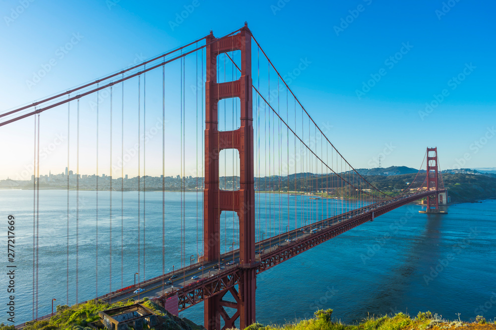 Golden Gate Bridge at sunrise and blue sky in San Francisco , USA Golden Gate Bridge at sunrise and blue sky in San Francisco , USA
