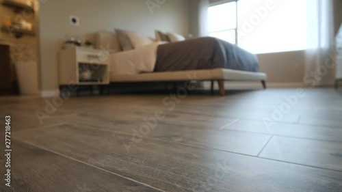 Bedroom Hardwood Closeup Move Right. view moves right on a low angle shot of a bedroom scene with focus on the hardwood floors