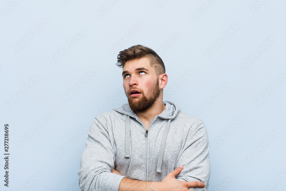 Young handsome fitness man tired of a repetitive task. Young handsome fitness man tired of a repetitive task.