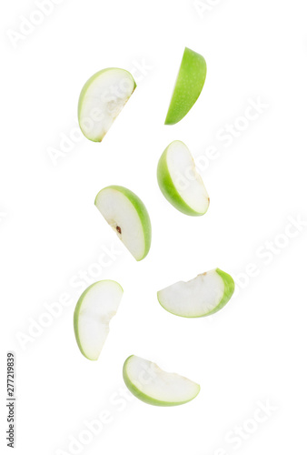 Photos Slice ripe green apple falling isolated on white background with clipping path