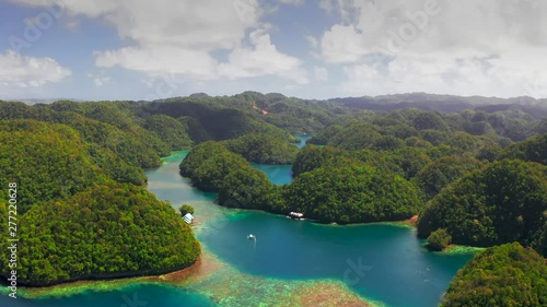 Tropical sea bay and lagoon, beach in Bucas Grande Island, Sohoton Cove, Philippines. Tropical landscape hill, mountains rocks with rainforest and azure water of lagoon. photo