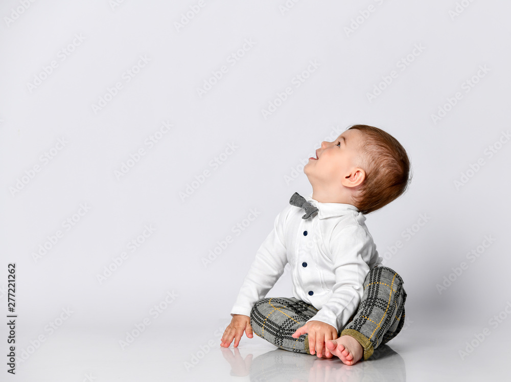 Happy baby. Little boy in a white shirt and bow tie. Children portrait. Stylish man in fashionable a bow-tie. Happy baby. Little boy in a white shirt and bow tie. Children portrait. Stylish man in fashionable a bow-tie.