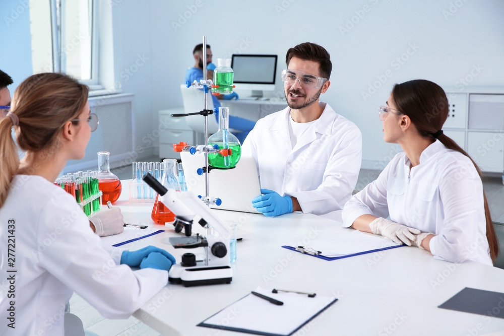 Medical students working in modern scientific laboratory Medical students working in modern scientific laboratory