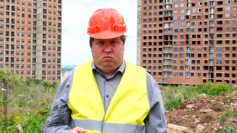 Male builder foreman, worker or architect on construction building site is pointing you are crazy Male builder foreman, worker or architect on construction building site is pointing you are crazy