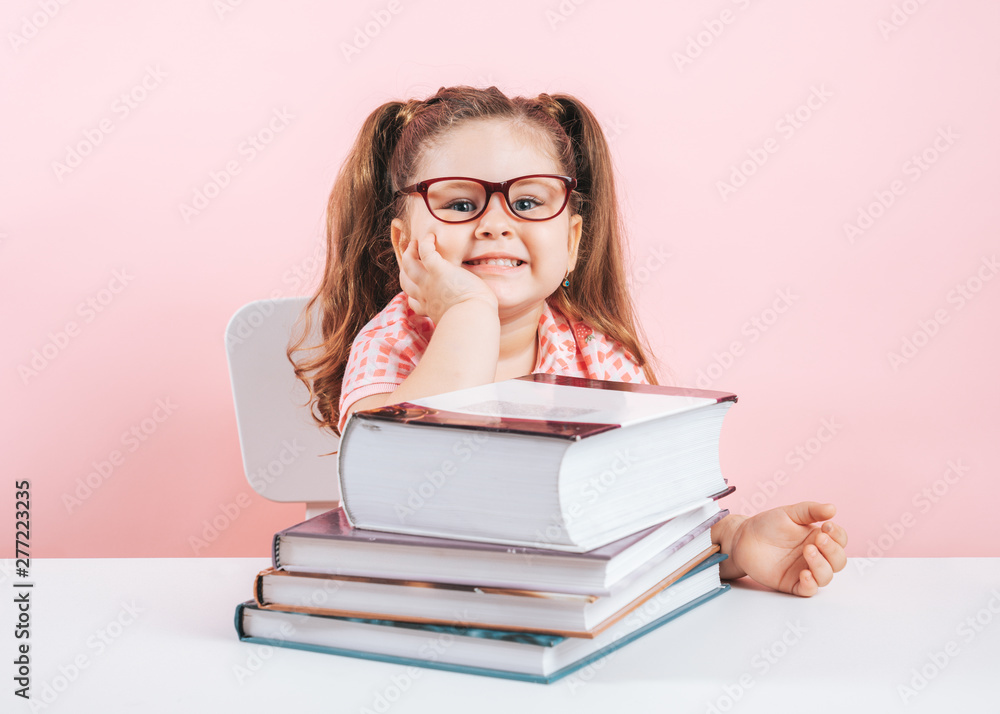 smiling blond little cute girl studying on books smiling blond little cute girl studying on books