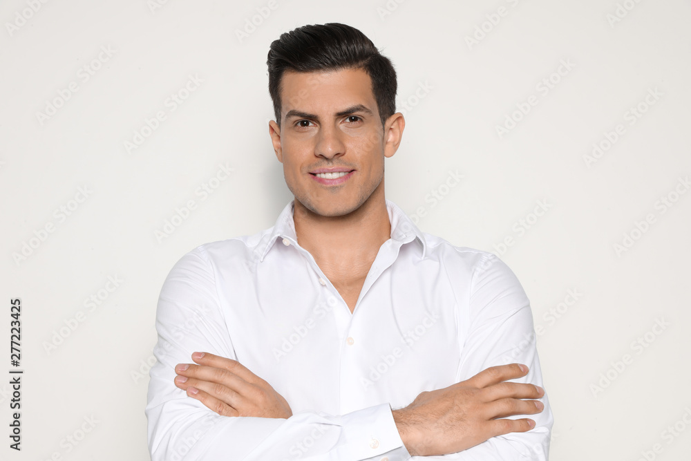 Portrait of handsome man smiling on light background Portrait of handsome man smiling on light background
