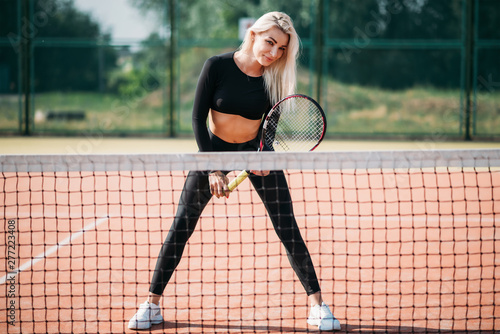Young beautiful woman playing tennis on a court. Healthy sport lifestyle © Lazy_Bear