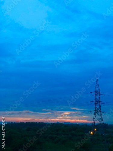 electricity pylons at sunset © Ishita