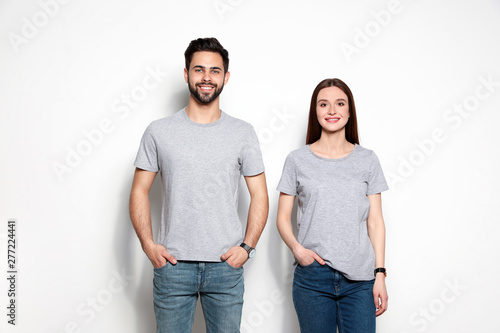 Young people in t-shirts on light background. Mock up for design