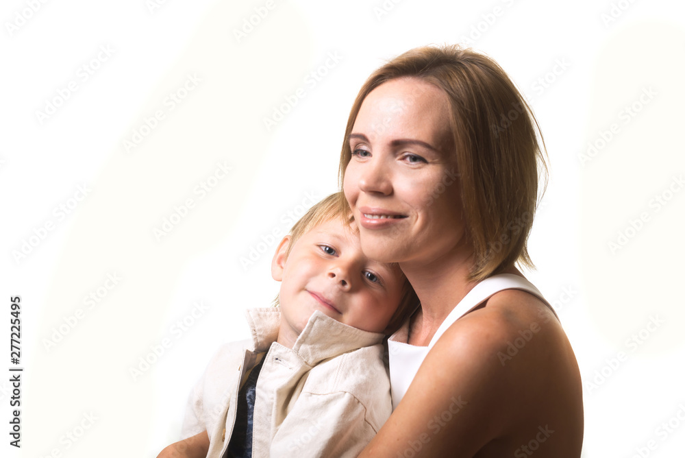 Happy mom and little son are hugging isolated on white background. Mother and child relationship. Happy mom and little son are hugging isolated on white background. Mother and child relationship.