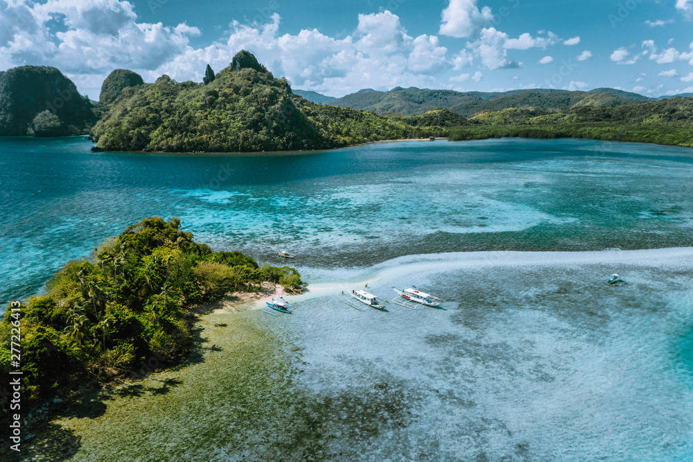 Aerial view of turquoise water and sandbar on tropical Vigan Snake Island, tourist attractions, tour trip El Nido Marine Reserve Park, Philippines