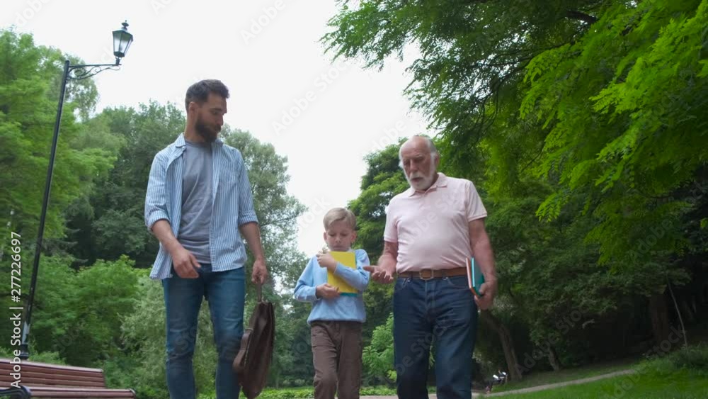 Family Generations concept: Father, son and Granddad, outdoors, in Nature, enjoying their Quality Time together, All in nice wear take child to school. Family Generations concept: Father, son and Granddad, outdoors, in Nature, enjoying their Quality Time together, All in nice wear take child to school.