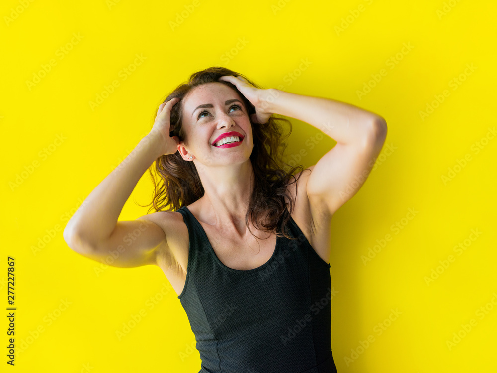 Fototapeta premium Young woman black gress is posing smiling coquetting