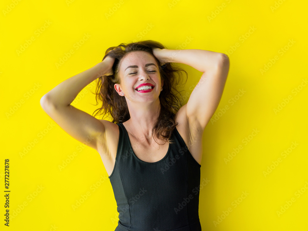 Fototapeta premium Young woman black gress is posing smiling coquetting