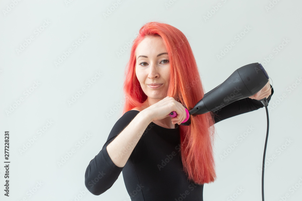 Stylist, fashion, hairdresser, people concept - woman drying her colored hair Stylist, fashion, hairdresser, people concept - woman drying her colored hair