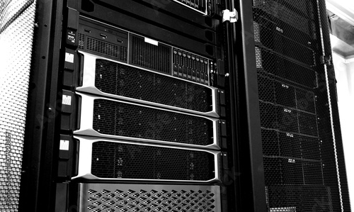 Blade server in rack cluster hard drives storage in internet data center room black and white tone photo