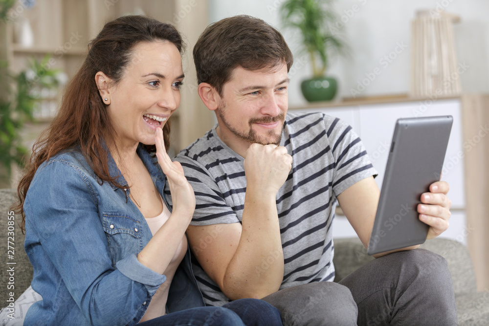 happy husband and his wife with tablet pc happy husband and his wife with tablet pc