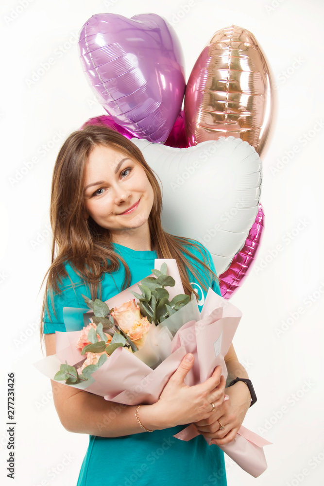 Happy girl with balloons in the studio on a white background in a dress on a festive day Happy girl with balloons in the studio on a white background in a dress on a festive day