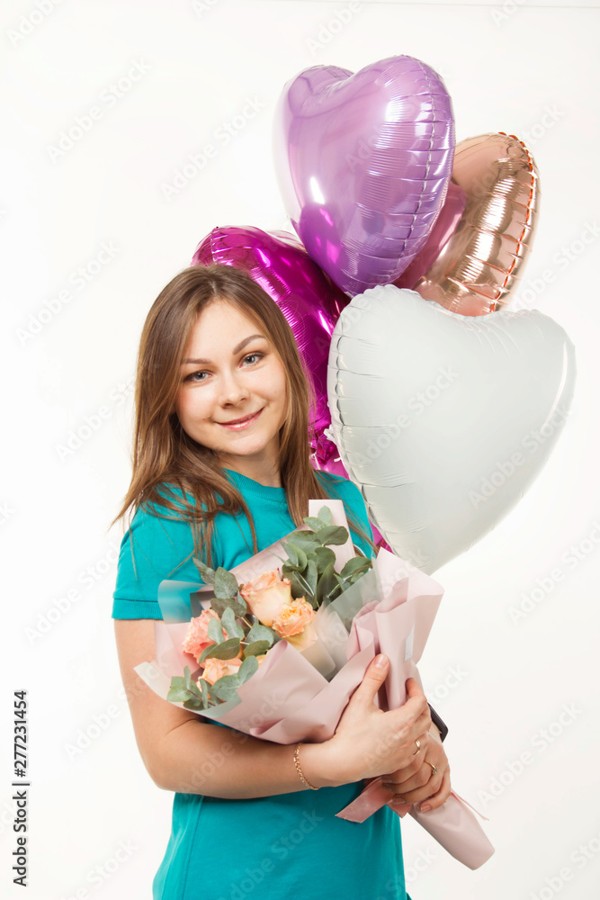 Happy girl with balloons in the studio on a white background in a dress on a festive day Happy girl with balloons in the studio on a white background in a dress on a festive day