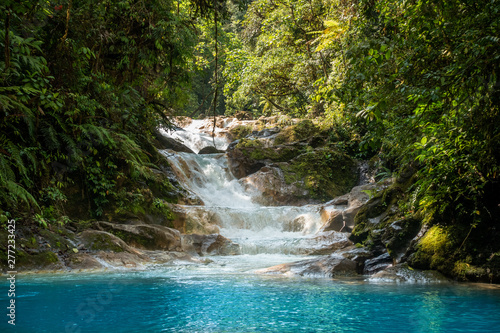 Blue falls of Costa Rica, natural landscape at Bajos del Toro close to the Catarata del Toro and San Jose. Photo taken at slow shutter speed and with ND filter. Smooth waterfall.  photo