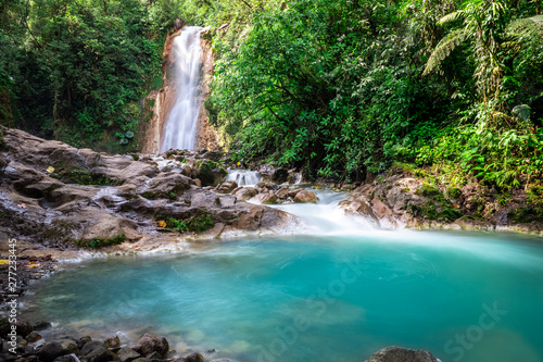 Blue falls of Costa Rica, natural landscape at Bajos del Toro close to the Catarata del Toro and San Jose. Photo taken at slow shutter speed and with ND filter. Smooth waterfall. 