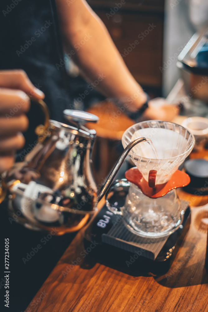 Naklejka premium Barista making drip coffee in coffee shop, barista cafe making coffee, coffee maker