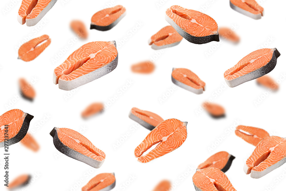 Falling salmon, trout, steak, slice of fresh raw fish, isolated on white background, selective focus Falling salmon, trout, steak, slice of fresh raw fish, isolated on white background, selective focus