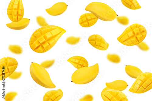 Obraz na płótnie Falling yellow mango isolated on white background, selective focus