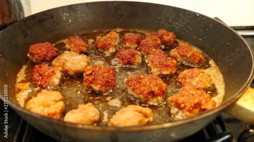 Frying Meatballs in the deep hot oil in the frying pan