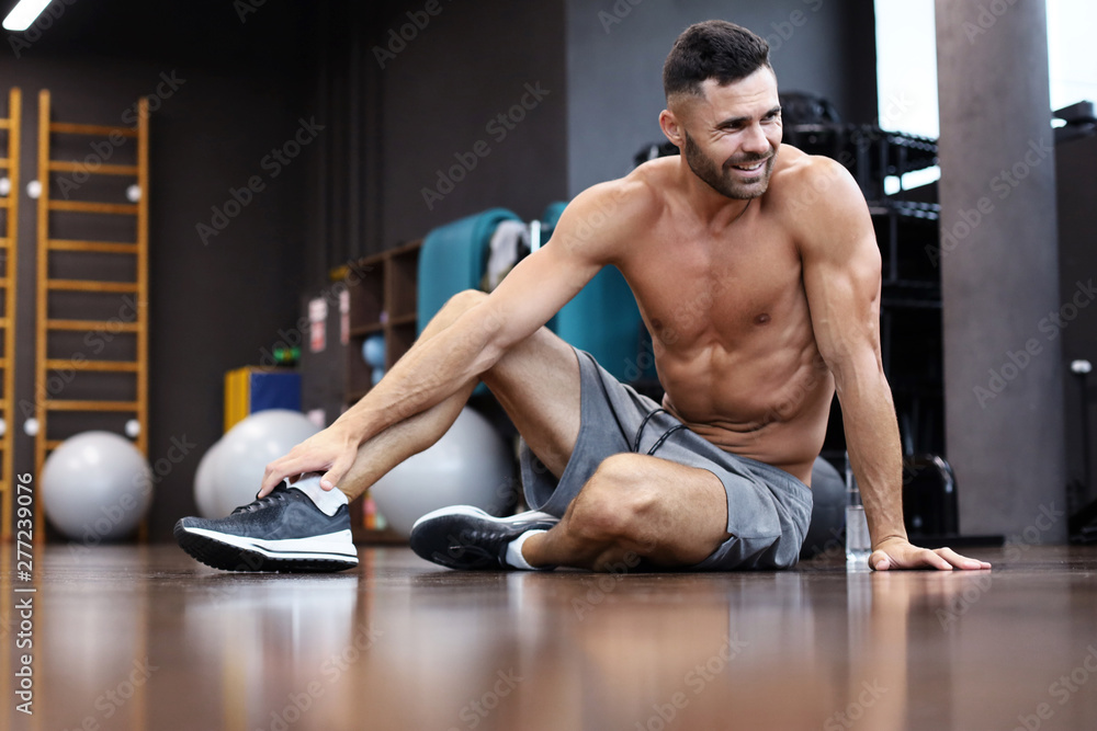 Sporty man resting, having break after doing exercise. Sporty man resting, having break after doing exercise.