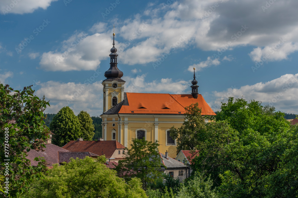 Old color church with red roof in Pecka town in hot summer sunny day Old color church with red roof in Pecka town in hot summer sunny day