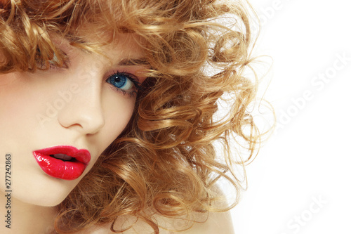 Young beautiful woman with curly hair and red lipstick. copy space