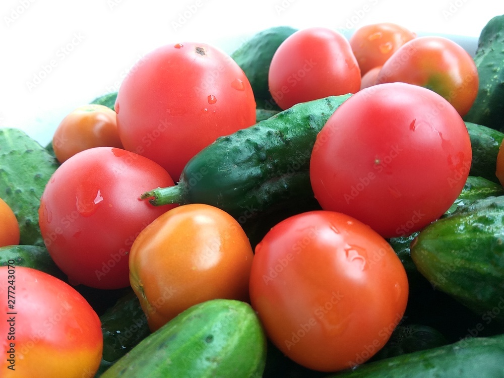 Food photo, red tomatoes and green cucumbers on white background