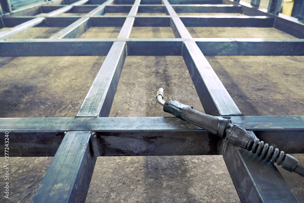 Welder lies on unfinished metal mesh metal, gas electric welding. Welder lies on unfinished metal mesh metal, gas electric welding.