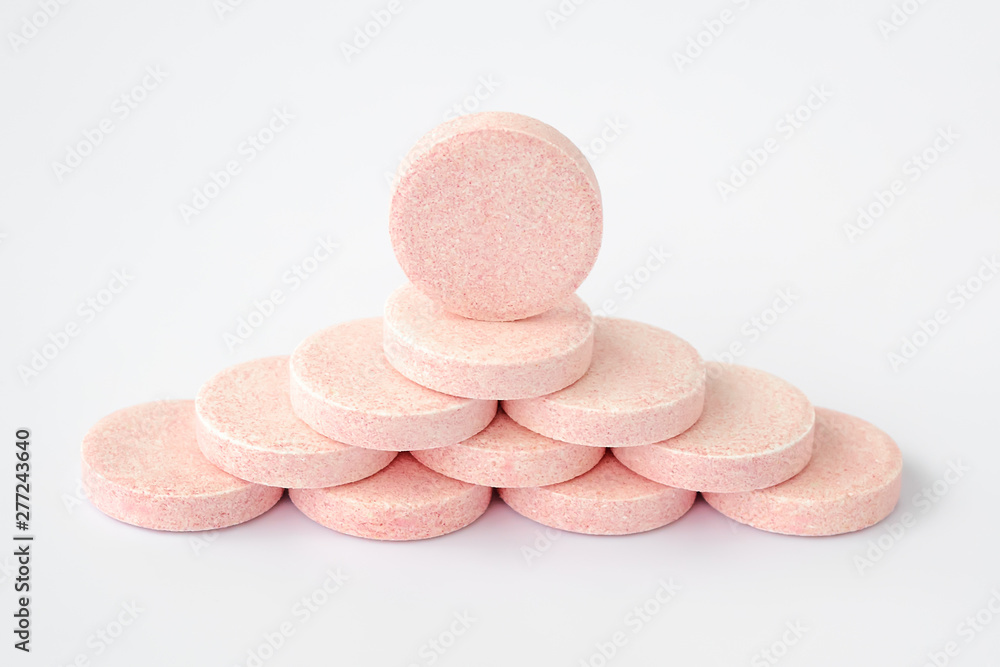 Pyramid of soluble effervescent vitamin tablets on a white background. Vitamins and nutritional supplements. Health care and medical. Pyramid of soluble effervescent vitamin tablets on a white background. Vitamins and nutritional supplements. Health care and medical.