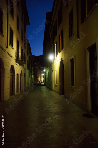 Illuminated lonely street at night. © M-Production