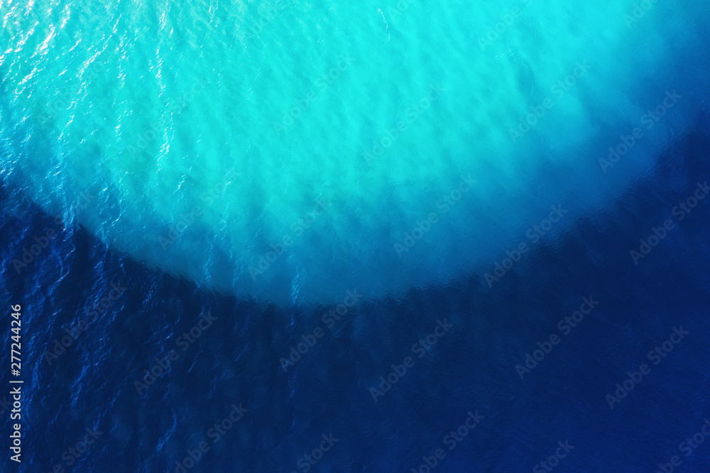 Aerial view at water background. Turquoise and blue water from air. Waves on the sea. Water background - image