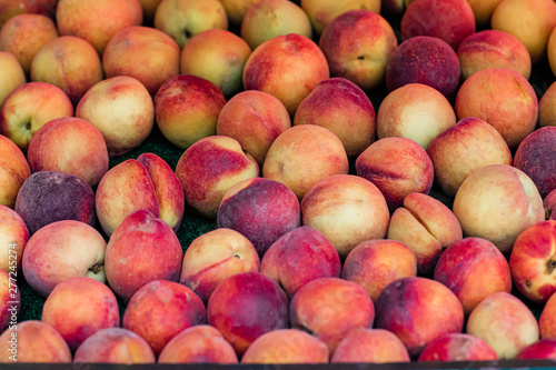 Box of Peaches on a Peach Fruit Stand at A Farrmer's Market Orchard in the Summer