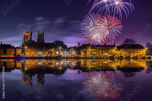 Firework display over town and river