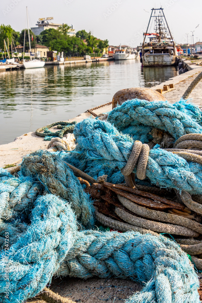 Close-up of old sunlit ship's rope at the channel-harbor, port canal of the port town of Cesenatico, Province of Forli-Cesena, Region of Emilia-Romagna, Italy