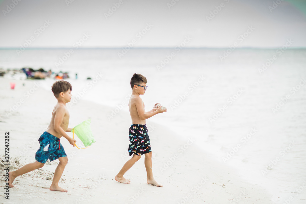 Two boys playing in the ocean in Florida on Vacation Two boys playing in the ocean in Florida on Vacation