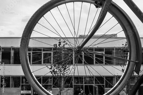 Bicycle wheel on the background of the production building
